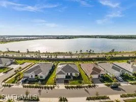 Aerial perspective of suburban area featuring a nearby body of water