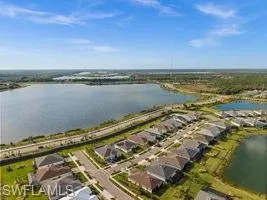 View of property location featuring a nearby body of water and nearby suburban area