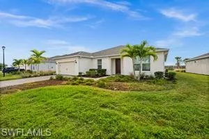 View of front of house with a front lawn, driveway, and a garage