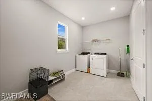 Laundry area featuring washer and clothes dryer and recessed lighting