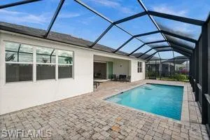 Outdoor pool with a sunroom, a lanai, and a patio