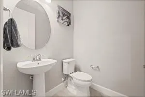 Bathroom featuring baseboards and tile patterned floors