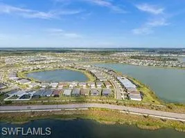 Aerial overview of property's location with a nearby body of water and nearby suburban area