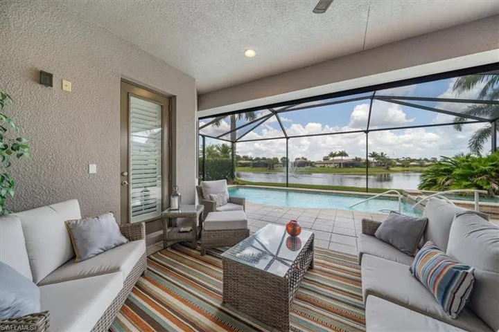 Sunroom / solarium featuring a water view