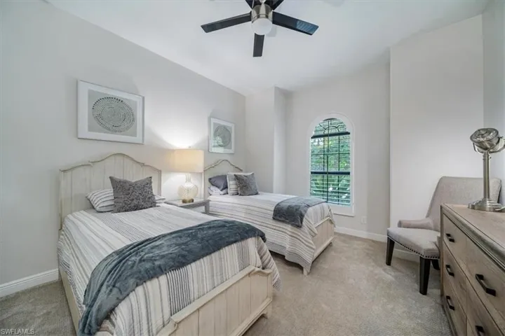 Bedroom featuring ceiling fan and light colored carpet