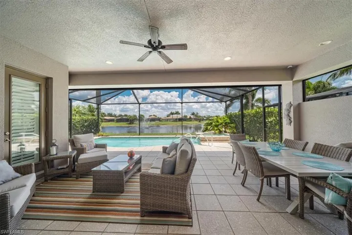 Sunroom featuring a water view and ceiling fan