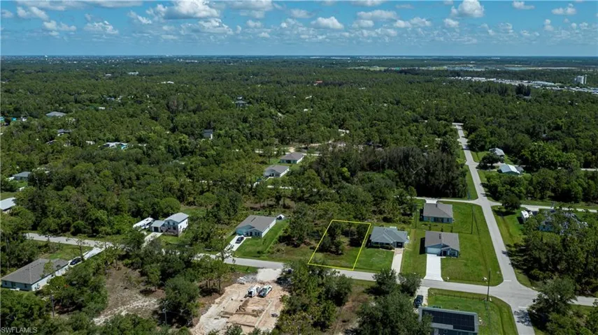 Aerial view of property's location featuring a forest and property parcel outlined