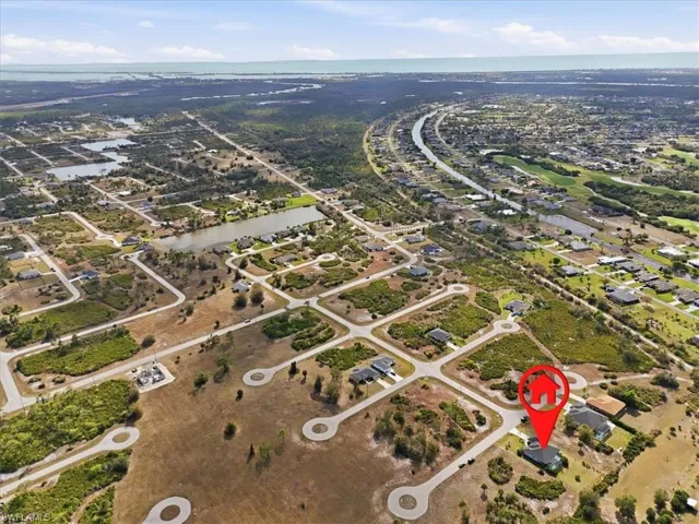 Aerial view of property and surrounding area with nearby suburban area