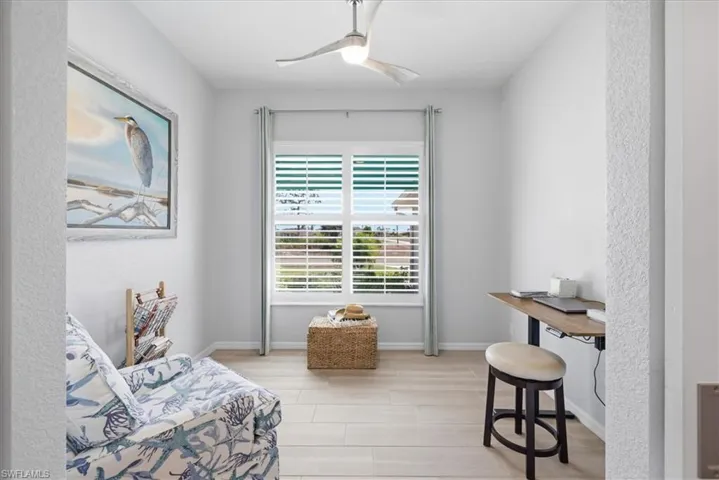 Living area with wood tiled floors and a ceiling fan
