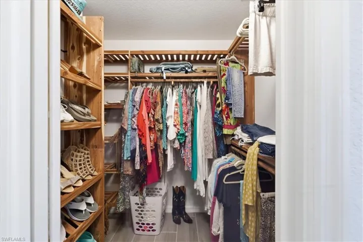 Walk in closet featuring wood finished floors