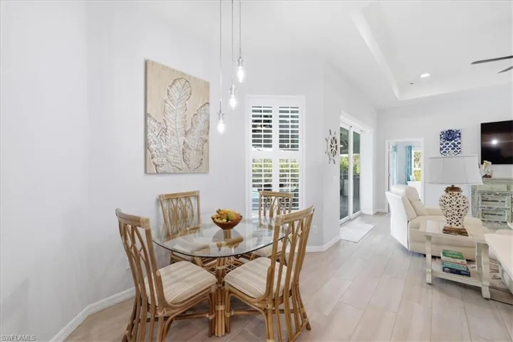 Dining space featuring recessed lighting, a ceiling fan, and a tray ceiling