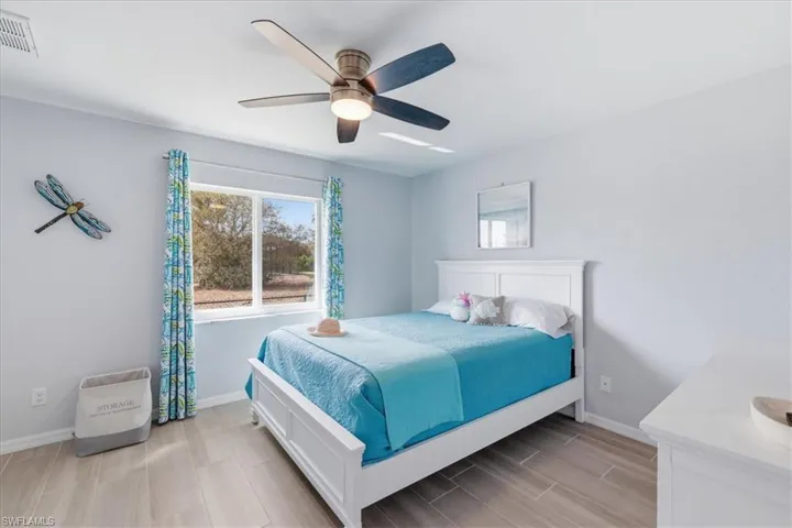 Bedroom featuring wood finish floors and a ceiling fan