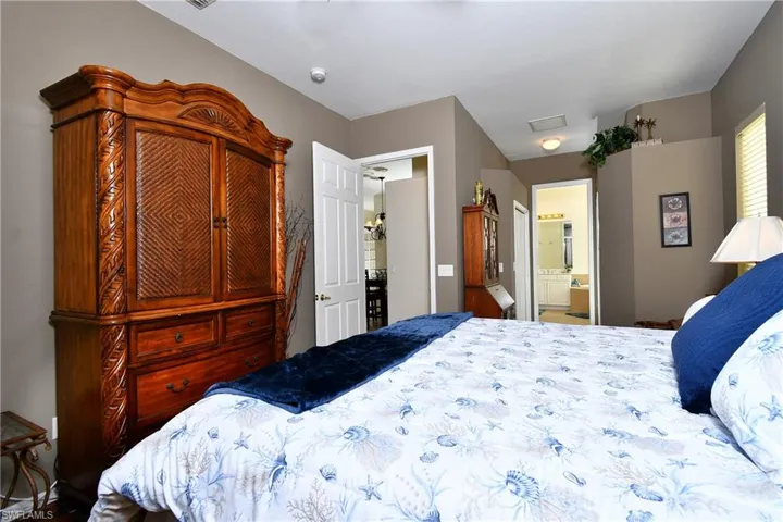 walk in closets flank the hallway to the primary bathroom