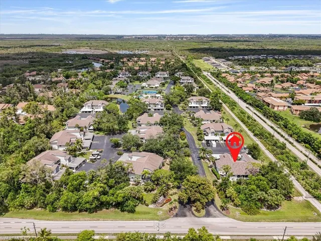 Aerial perspective of suburban area featuring a nearby body of water