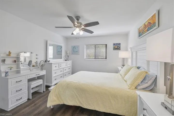 Bedroom featuring dark wood-style flooring and a ceiling fan