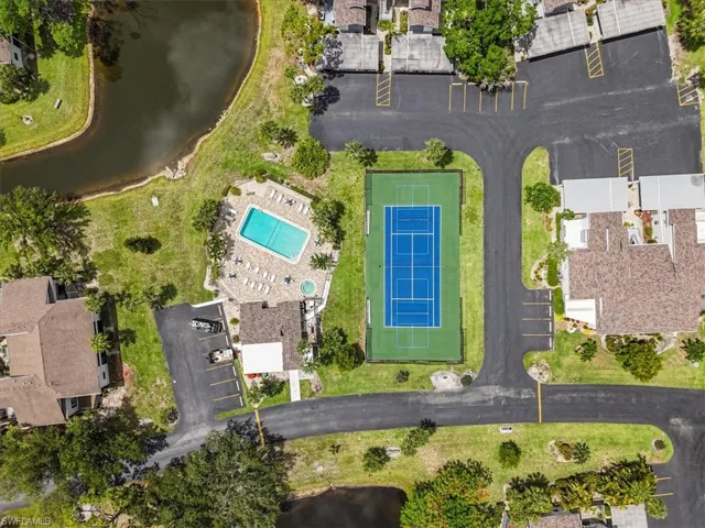 Aerial overview of property's location with a nearby body of water and a pool area