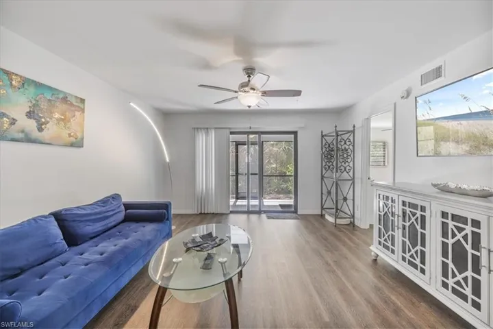 Living room with wood finished floors and ceiling fan