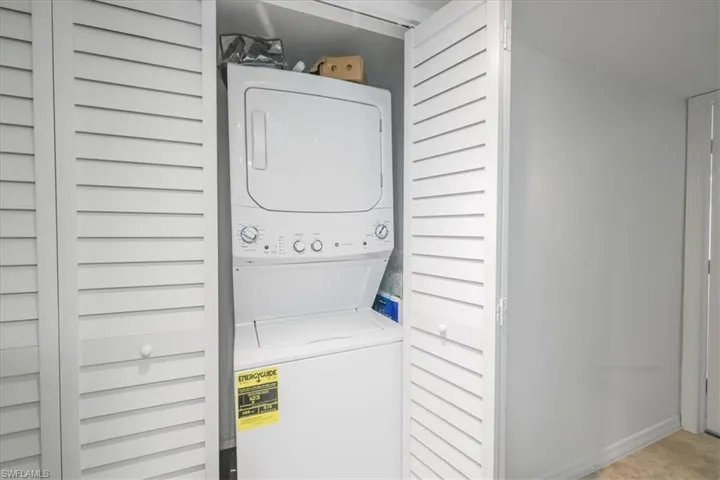 Laundry area featuring stacked washer / drying machine