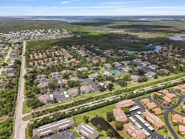 Aerial overview of property's location featuring nearby suburban area and a nearby body of water