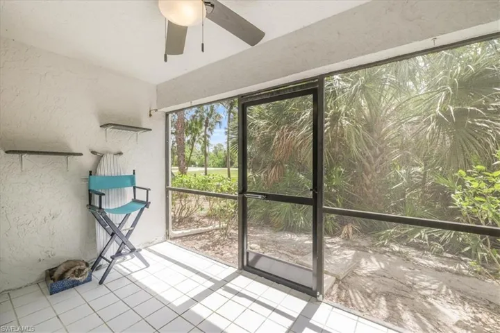 Unfurnished sunroom with ceiling fan
