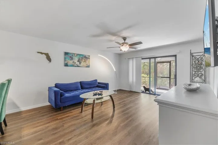 Living room featuring dark wood finished floors and ceiling fan