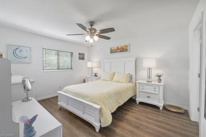 Bedroom with dark wood-type flooring and ceiling fan