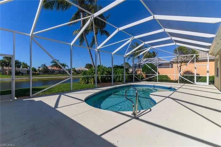 Outdoor pool with a sunroom, a patio area, a lanai, and a water view