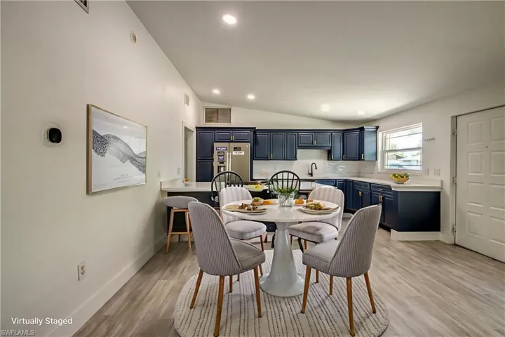 Dining space featuring lofted ceiling, light wood-type flooring, and recessed lighting