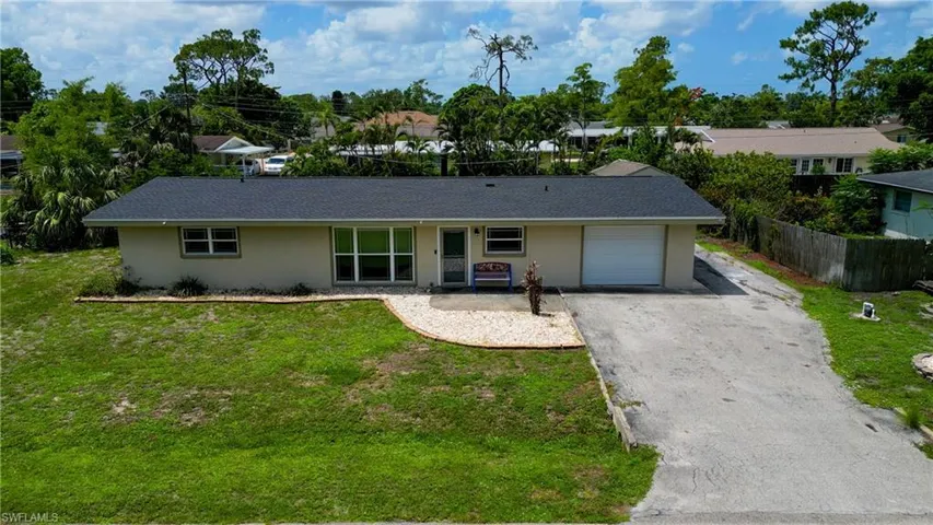 Ranch-style house with an attached garage, asphalt driveway, stucco siding, and a shingled roof