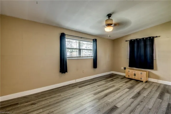 Unfurnished room featuring wood finished floors and a ceiling fan
