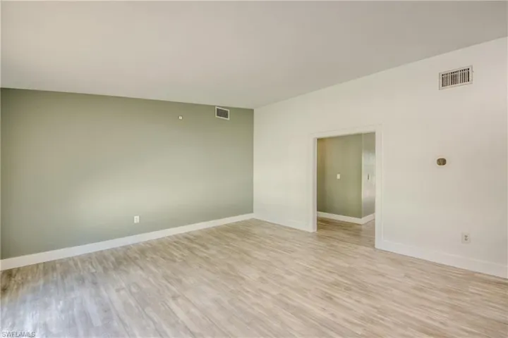 Unfurnished room featuring light wood-style flooring and baseboards