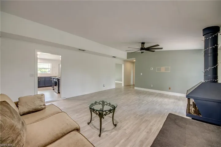 Living room with ceiling fan and light wood-style floors