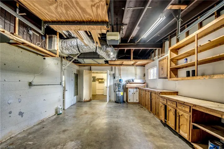 Garage featuring water heater and a garage door opener