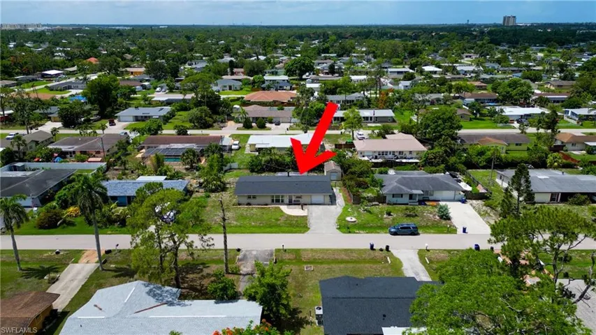 Aerial view of property's location with nearby suburban area