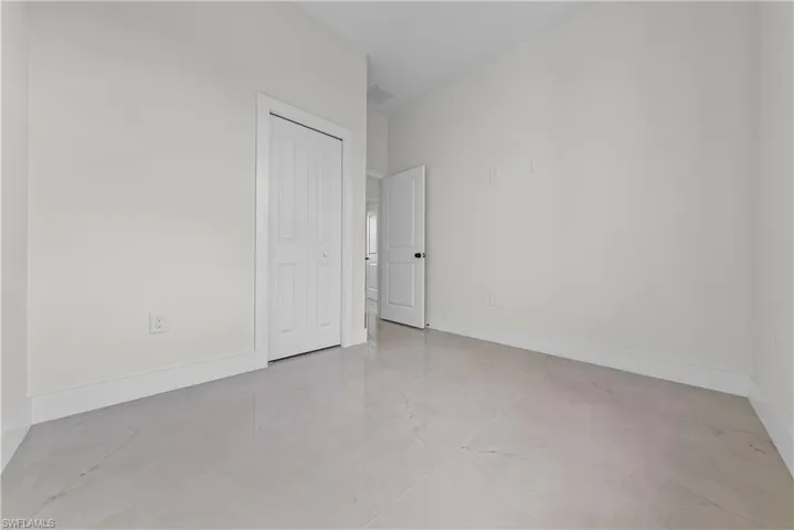 Unfurnished bedroom featuring baseboards and a closet