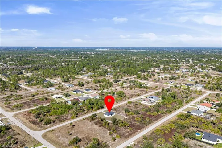 Aerial overview of property's location with nearby suburban area