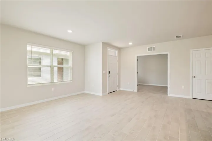 Empty room with light hardwood / wood-style floors