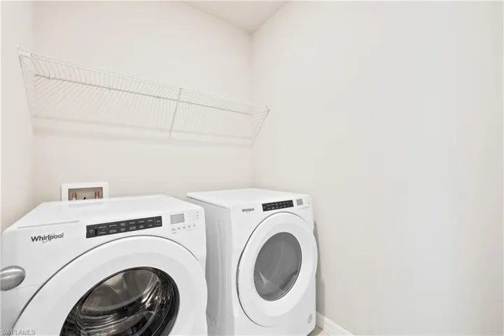 Washroom featuring washing machine and dryer