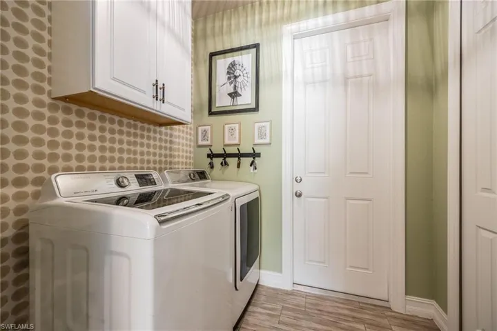 Laundry area with cabinets and washing machine and dryer