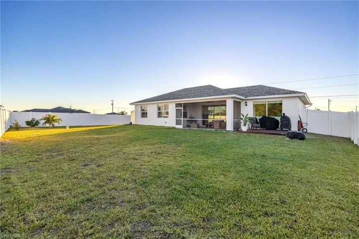 Back of property featuring a yard