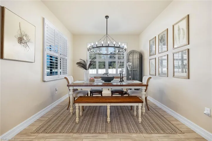 Dining space featuring light hardwood / wood-style floors and an inviting chandelier