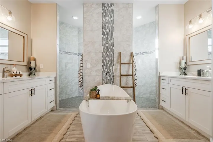 Bathroom featuring vanity and shower with separate bathtub