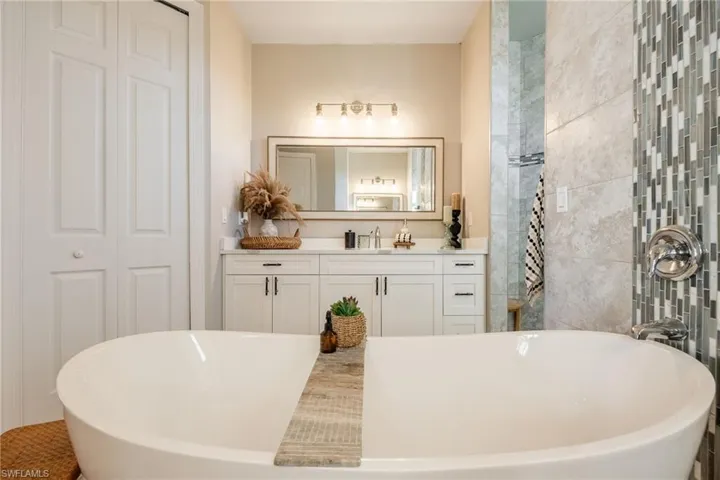 Bathroom featuring vanity and a tub to relax in