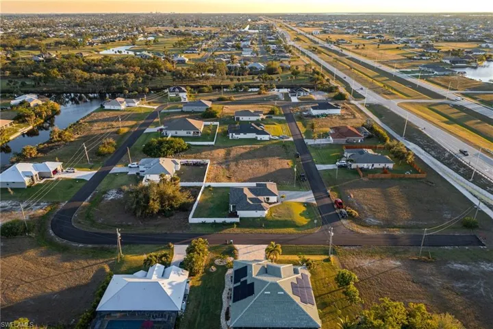 Aerial view at dusk featuring a water view