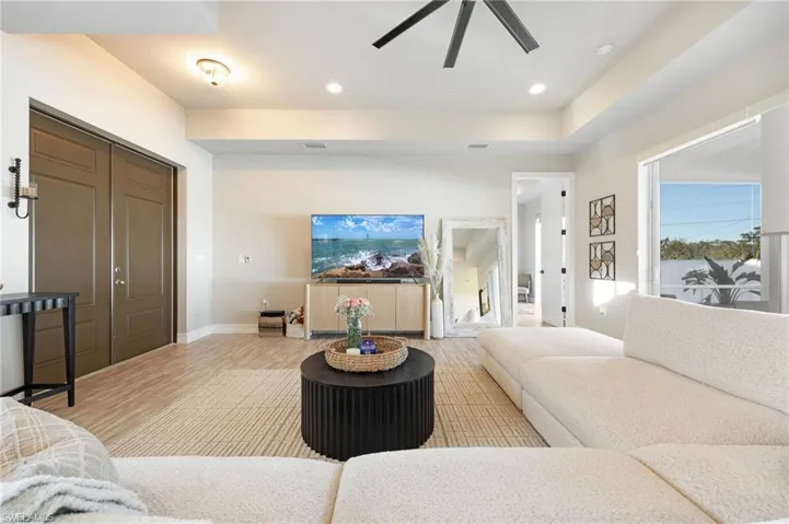 Living room featuring light wood-type flooring and ceiling fan