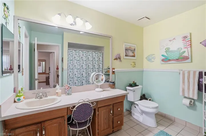 Primary Bathroom featuring vanity, shower/tub and light tile