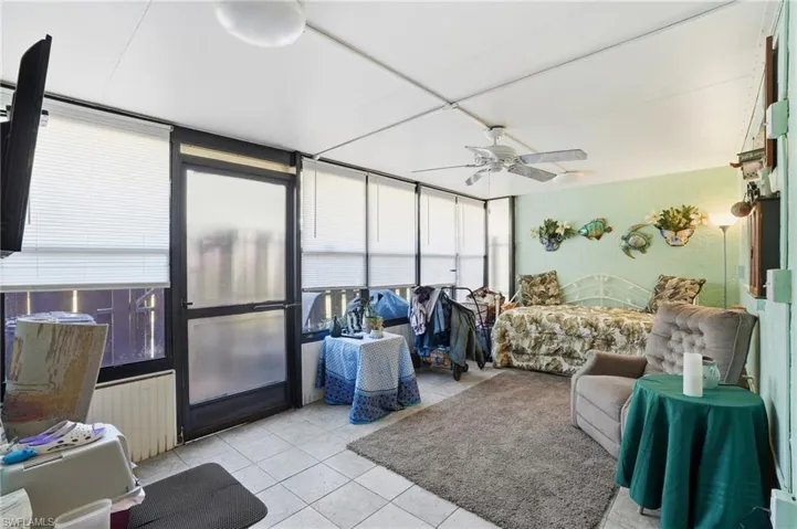 Enclosed Lanai/sunroom, light tile floors and ceiling fan