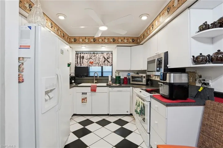 Kitchen with open shelves and ceiling fan