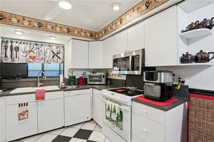 Kitchen with open shelves, pass thru to lanai