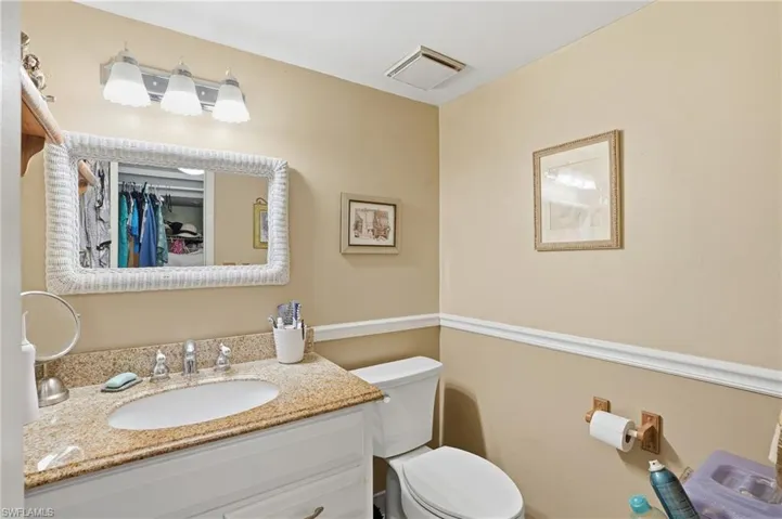 Downstairs half Bathroom with toilet and vanity
